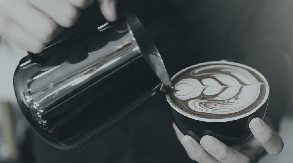 Dartcor Food Services Corporate Dining Team prepares latte with foam design
